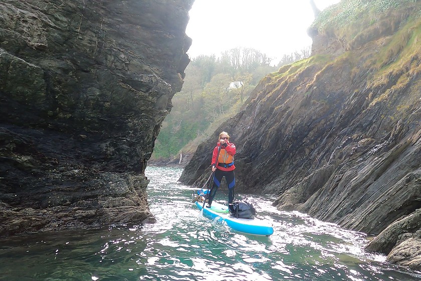 paddleboarder in rocky gully
